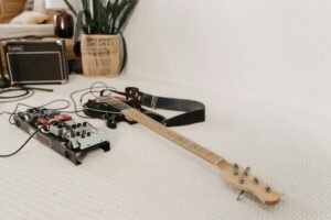 Guitar with strap on carpet